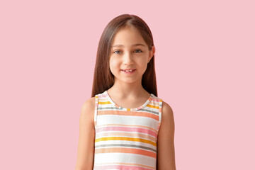 Fototapeta premium Cute little girl smiling on pink background