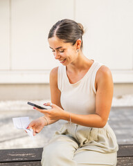 Young woman sit scan invoice with cellphone have contactless payment