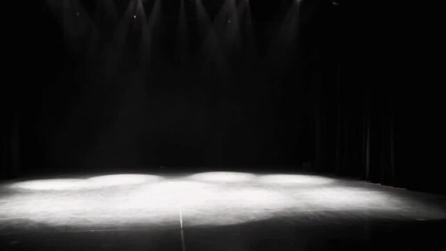 Stage lights shining at studio. Seamless looping animation. Artistic performances stage light background with spotlight illuminated the stage for contemporary dance. Empty stage with monochromatic col