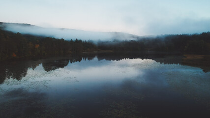 Calm Mirror Lake in Upstate Vermont with Low Hanging Clouds. Nature Landscape Serene Background Blue Hour Close to Sunset Nature