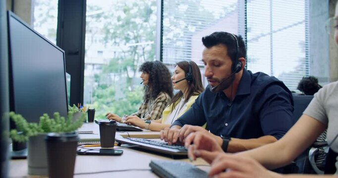 Professional diverse managers remotely offering customers new products and company services. Workers using headset for remote consultation. Entering call information on computers. Contact center.