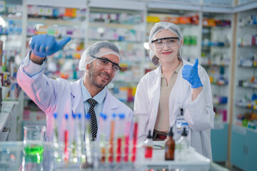 scientists perform experiments and record data. people arranges equipment with test tubes and chemicals for producing medicine and biochemistry. man hold tubes of chemical liquids and plant samples.