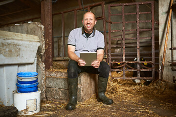 Portrait, man or farmer with tablet for dairy farm, herd management and track production of animals. Agriculture, business owner and online with digital for research, information and access resources