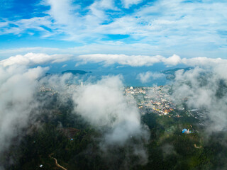 Aerial view of flowing fog waves on mountain tropical rainforest,Bird eye view image over the...