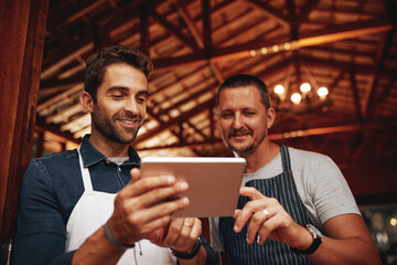 Men, tablet and barista with pride, small business and colleagues as entrepreneur in cafe. Male people, waiter and technology in industry, hospitality or customer service with confidence at workplace