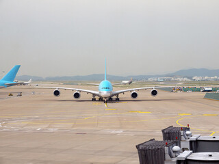 Wide-body twin-deck airliner taxiing on the ground after landing