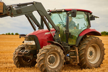 Farming, man and tractor in land for care, ground maintenance and hay in countryside. Person,...