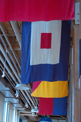 The ceiling of a building in Norwalk, Connecticut displays nautical flags, each representing a letter of the alphabet