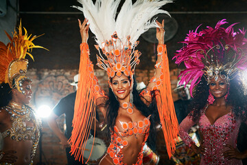 Celebration, women and portrait with costume for dancing, carnival and expression of Brazilian culture. Festival, people or tradition with dancers for performance, creativity or energy at night event