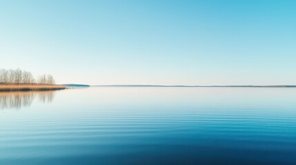 Fototapeta premium Calm Lake with Blue Sky and Distant Shoreline