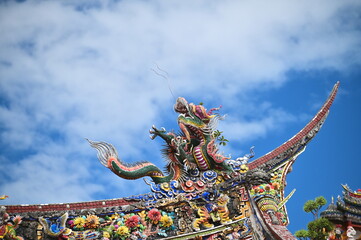 Close-up of the dragon cut-and-paste art on the eaves of Taipei Baoan Temple. This technique blends...