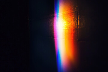 Obraz premium Rainbow light flare on the wall. Lens spectrum leak. Abstract wallpaper design.