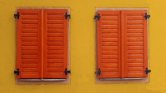 Tow windows with closed wooden shutters