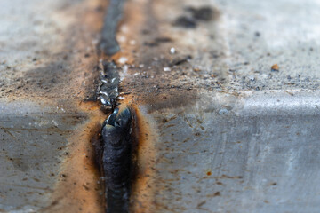 A rusty metal object with a burn mark on it