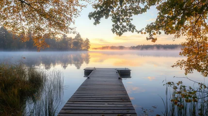 Selbstklebende Fototapeten Sunset on the lake with wooden pier in autumn © PixMarket