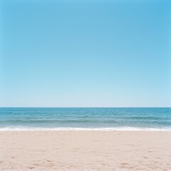 Fototapeta premium Sandy Beach with Clear Blue Sky and Ocean