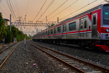 Obraz premium Modern electric passenger train entering the train station. Summer landscape in the background with photocopy blank rusng.
