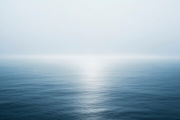 Obraz premium A Still, Misty Ocean With A Single Beam Of Light