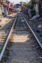 View of a train track with electricity poles along the tracks.