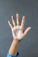 A Blue Circle Painted in The Palm of A Young Man. World Diabetes Day Concept.