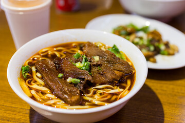 Taiwanese spicy red soup beef noodle in bowl