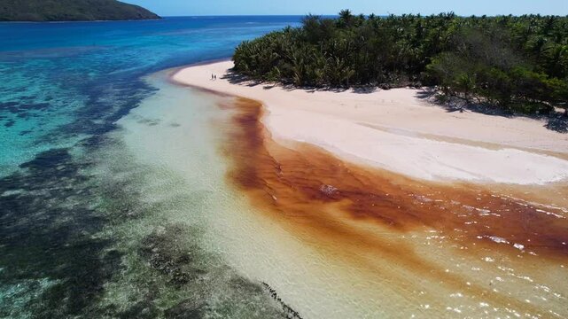 Aerial view of red algae bloom - Red Tide - on coral reef on record hot day in the south Pacific - The effect of climate change on coral reefs