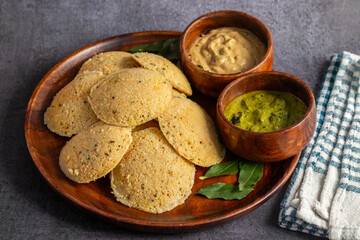Oats Idli is a healthy, steamed South Indian breakfast made with oats, semolina, yogurt, and spices, offering a nutritious twist. Selective focus.