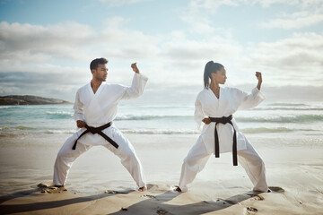 Sport, karate and team at beach for training, taekwondo or performance outdoor with student. Ocean, martial arts and people practice for fitness, exercise or workout with warrior or master at lesson © Flashizzle/peopleimages.com