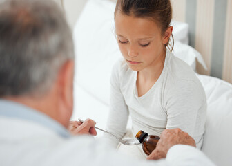 Child, medicine and sick in bed with doctor for cough treatment, lungs or medical consultation in...