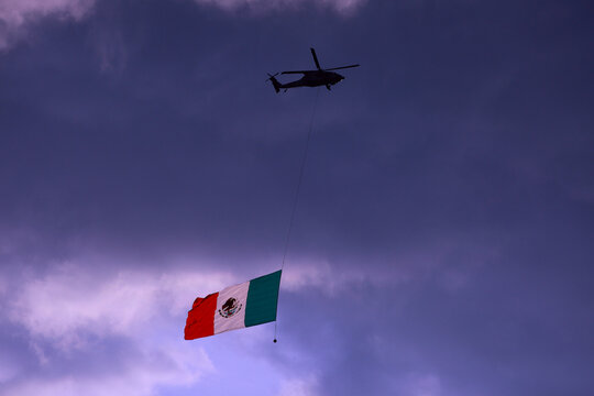 Ciudad de Mexico, Mexico - November 30. 2023: Helicopter in flight displaying a Mexican Flag