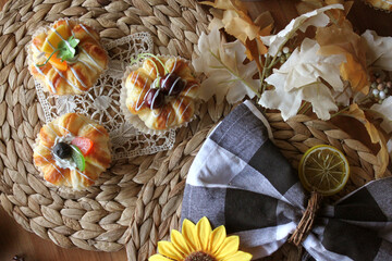 Homemade Chocolate Stick Candy with Sparkling Sugar in a Festive Halloween Bucket with Light Pastries on Wicker Place Mats with Sunflower and Buffalo Check Decor