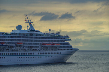 Luxury German cruiseship cruise ship ocean liner Artania sail away departure from Bremerhaven, Germany with pilot and tug boat summer cruise vacation