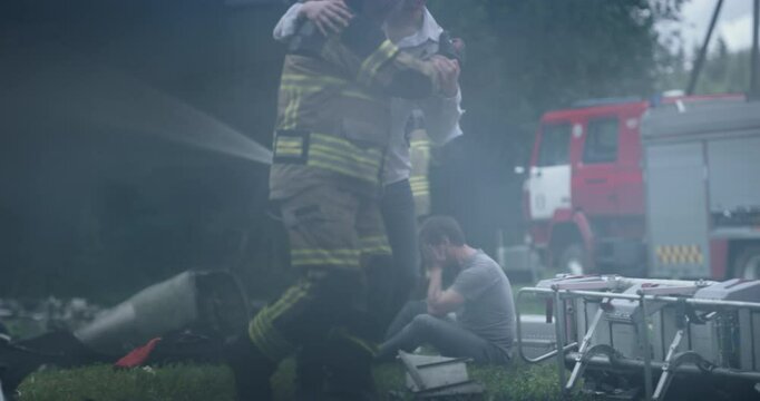 Rescue Team Working on Wreckage Site of a Crashed Airliner, Firefighters Extinguishing Flames while Paramedics Attend to Injured Passengers. Cinematic Footage Through Fire of an Urgent Situation