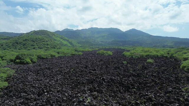 Stories of the Ceboruco volcano cover the black magma road with frozen rocks.