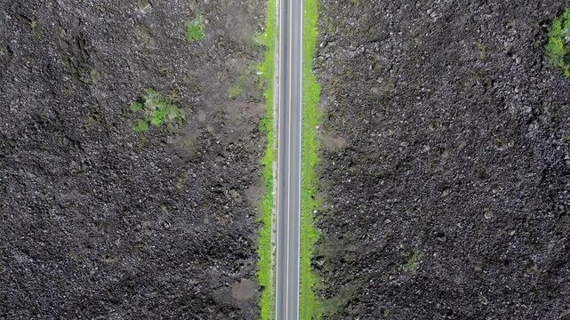 Stories of the Ceboruco volcano cover the black magma road with frozen rocks.