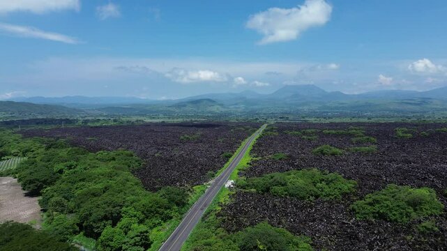 Stories of the Ceboruco volcano cover the black magma road with frozen rocks.