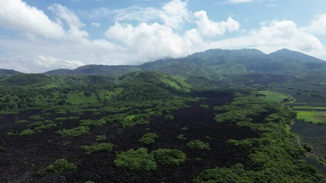 Stories of the Ceboruco volcano cover the black magma road with frozen rocks. Mexican roads.