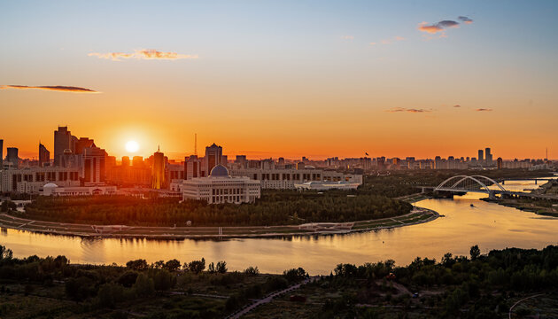 Sunset over the central part of the capital with a view of the Akorda Presidential Palace. The view from the height. Astana, Kazakhstan