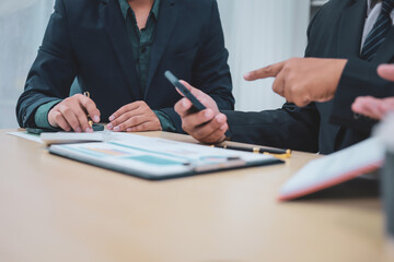 A lawyer meets with clients in a professional office, offering expert legal consultation and representation. Specializing in business planning, they operate within private firms or as freelance