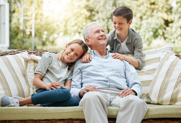 Fototapeta premium Grandfather, kids and happy in patio on couch at home for bonding, support and care. People, family and outside with smile or laugh on visit as babysitter for break, relax and rest on sofa for fun