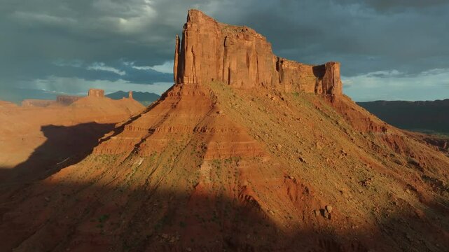 Aerial imagery above Moab desert scene with rocky outcrops and Mesa in 4K
