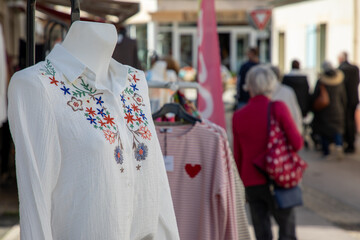 shop women fashion dress many cloths on clothing rack in outdoors boutique street market