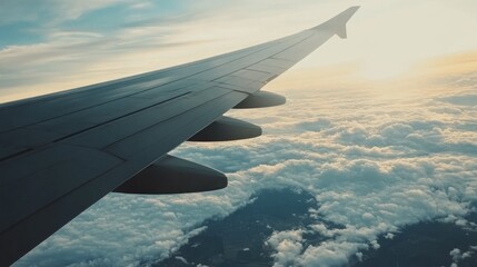 Obraz premium Awesome view of the Earth under the airplane wing. Amazing landscape is visible through airplane window. Traveling by plane. Flying in the sky among clouds.