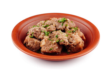 Stewed pork meat with herbs and spices on a plate