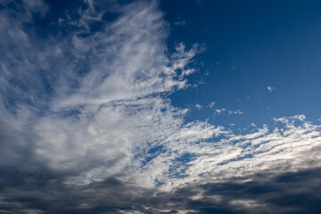 Obraz premium Section of blue sky with cumulus and cirrus clouds