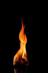 A candle flame burning in the dark.