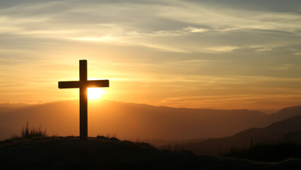 cross at sunset on hill background