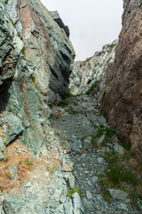 narrow mountain pass with rocks around - Passo delle Mangioire in Alpi Graie in Italy