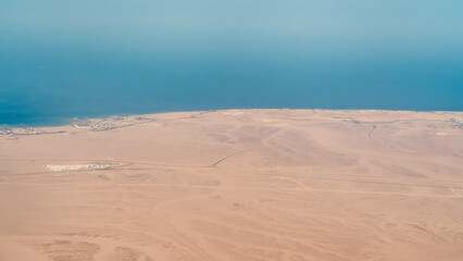 view from the plane window of the Red Sea and the desert in Egypt