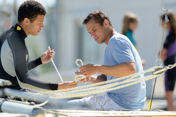Fototapeta premium two man drive a sport sailing yacht in competition